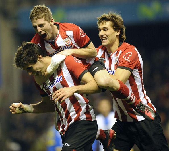 Athletic Bilbao's midfielder Javi Martinez (L) celebrates a goal with teammates forward Fernando Llorente (R) and forward Iker Muniain (C) during the Spanish league football match Athletic Bilbao vs Espanyol, at San Mames stadium, in Bilbao, on February 4, 2012. (Getty Images)